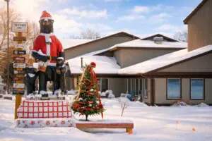 Nisswa Hotel & Suites winter exterior featuring our bear mascot dressed for the holidays