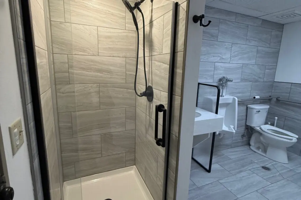 Shared bathroom with walk-in shower near pool and spa at Nisswa Hotel & Suites in Nisswa MN