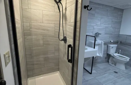 Shared bathroom with walk-in shower near pool and spa at Nisswa Hotel & Suites in Nisswa MN
