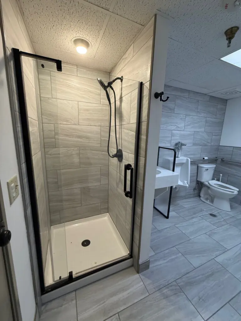 Shared bathroom with walk-in shower near pool and spa at Nisswa Hotel & Suites in Nisswa MN