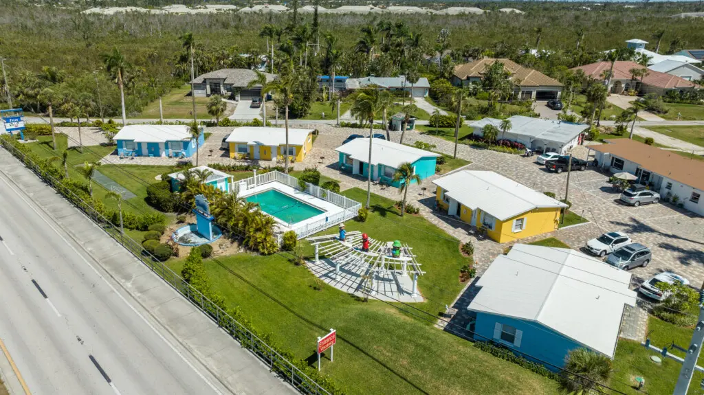 Waterfront vacation rental community in Fort Myers Florida with pool, palm trees, and coastal cottages