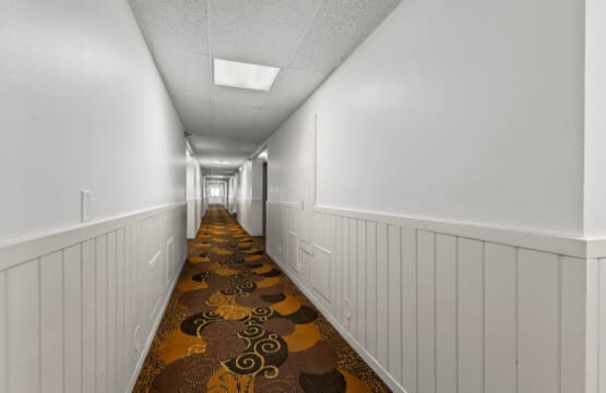 Clean hotel hallway at Nisswa Hotel & Suites in Nisswa MN leading to guest rooms